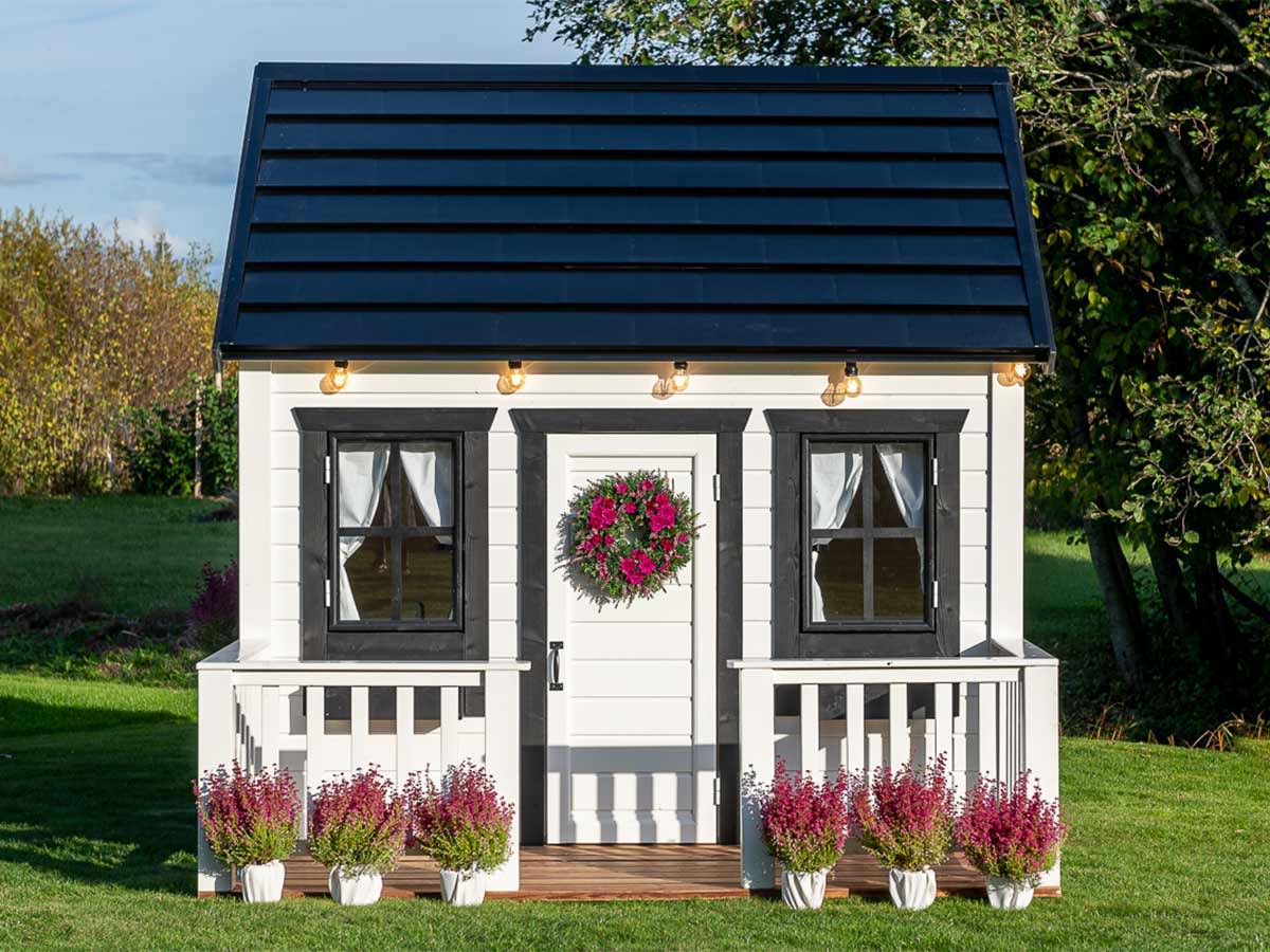 White and Black Outdoor Playhouse Blackbird with black roof and flower boxes, wooden terrace and white door by WholeWoodPlayhouses