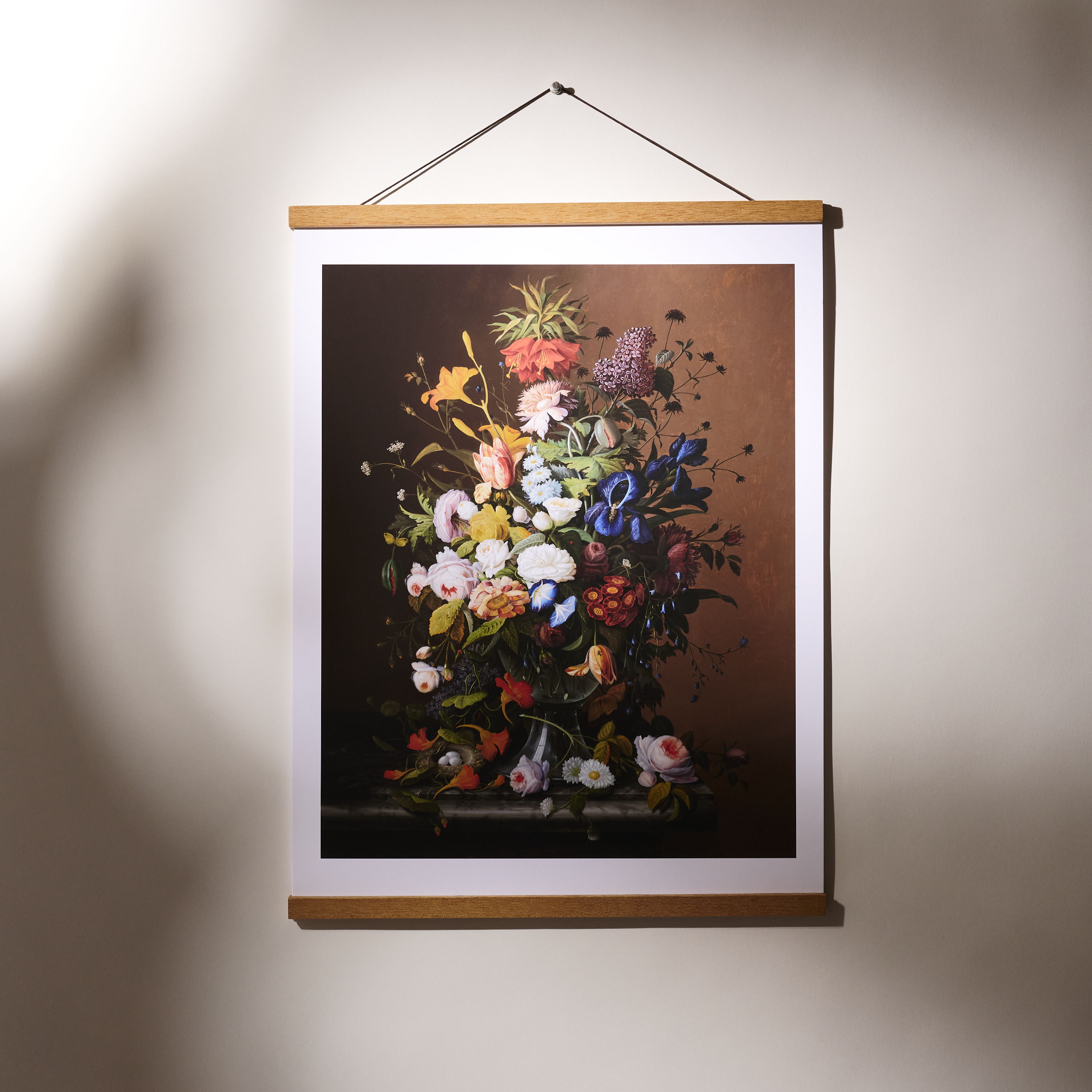 A floral poster hanging on a wall with a wooden frame.