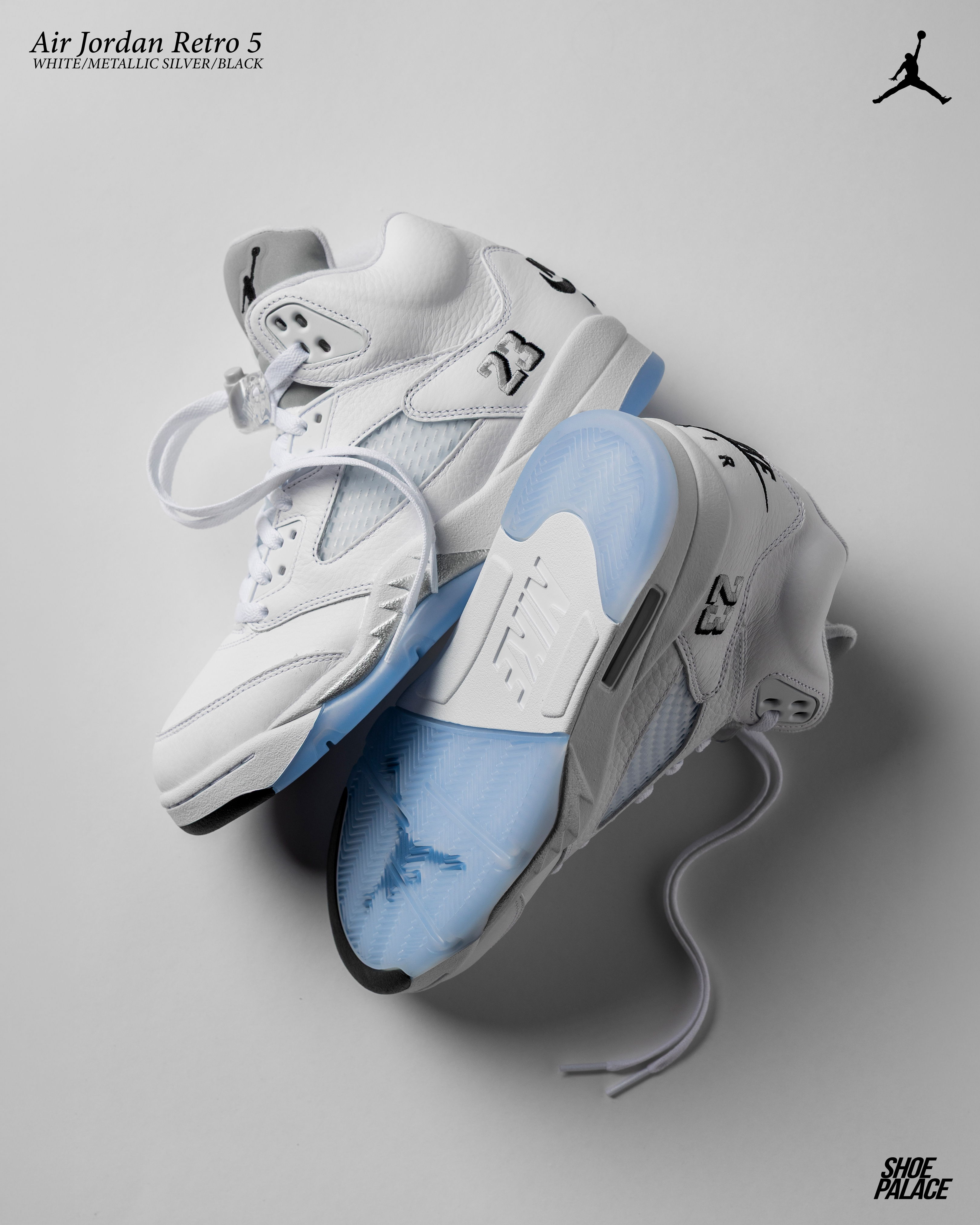 Air Jordan Retro 5 sneakers in white and light blue on a gray background.