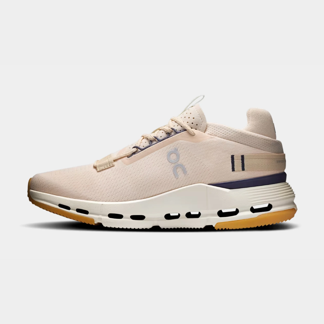 Light pink athletic shoe with a white sole and purple accents.