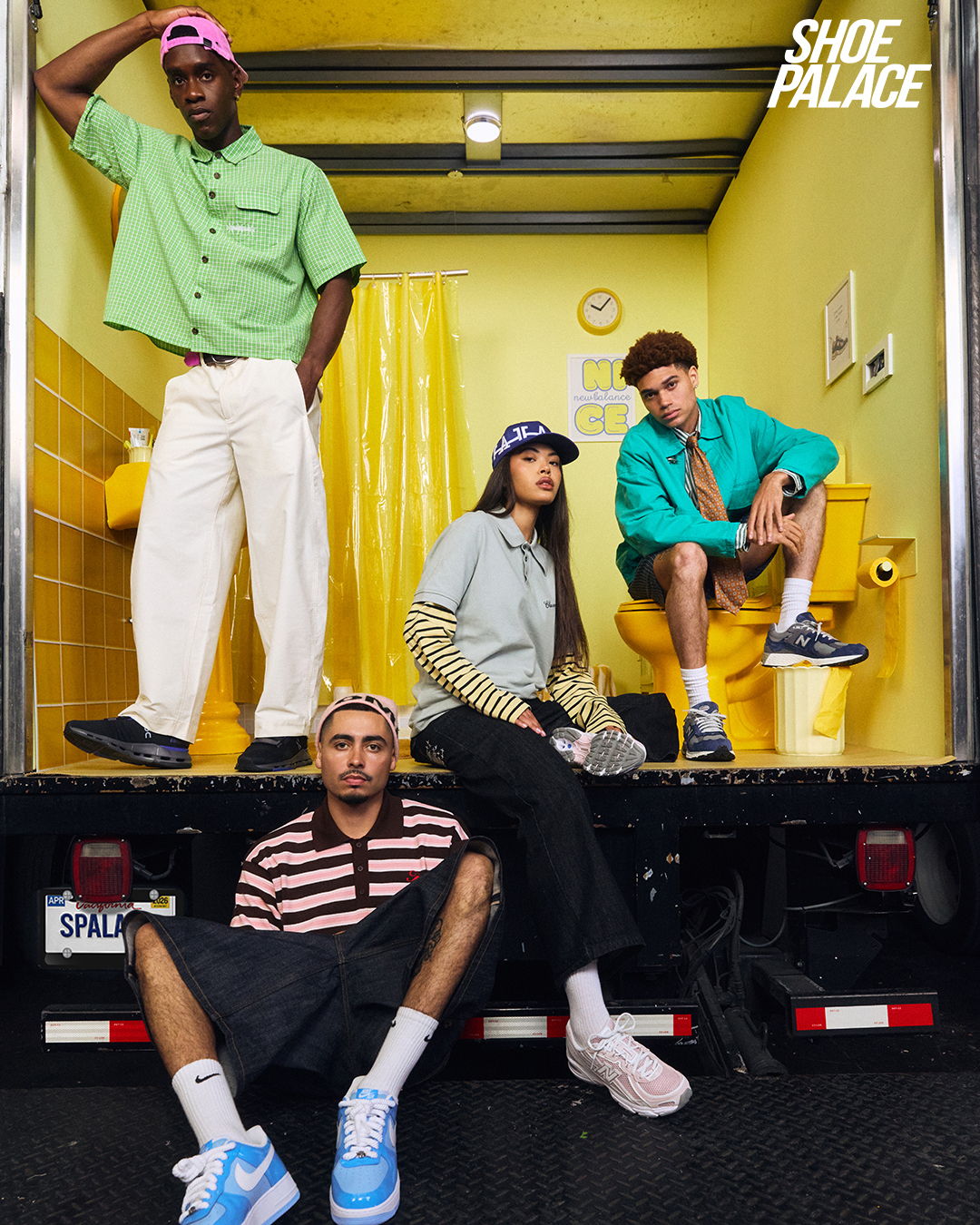 Four young adults posing in a colorful truck interior, showcasing trendy outfits.