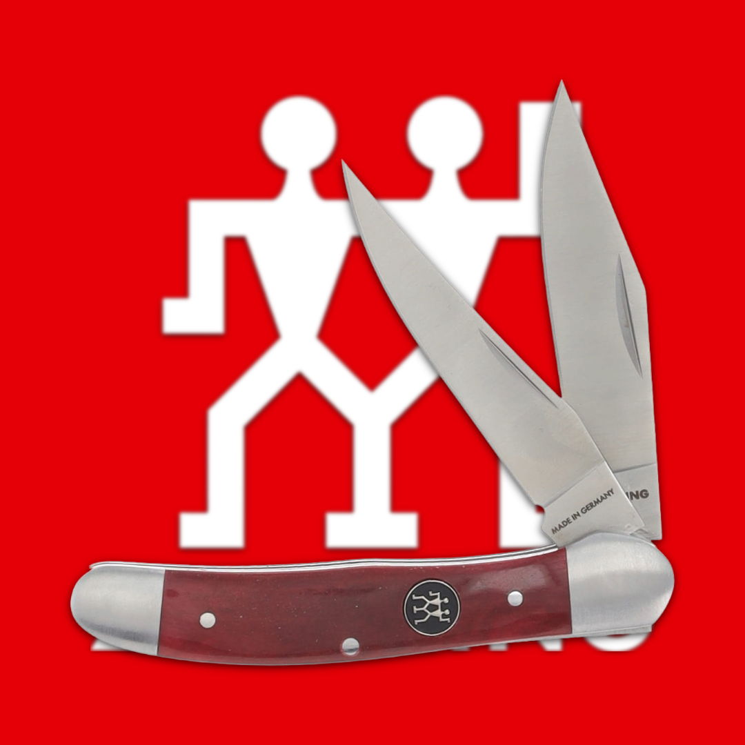 A folding knife with two blades on a red background.