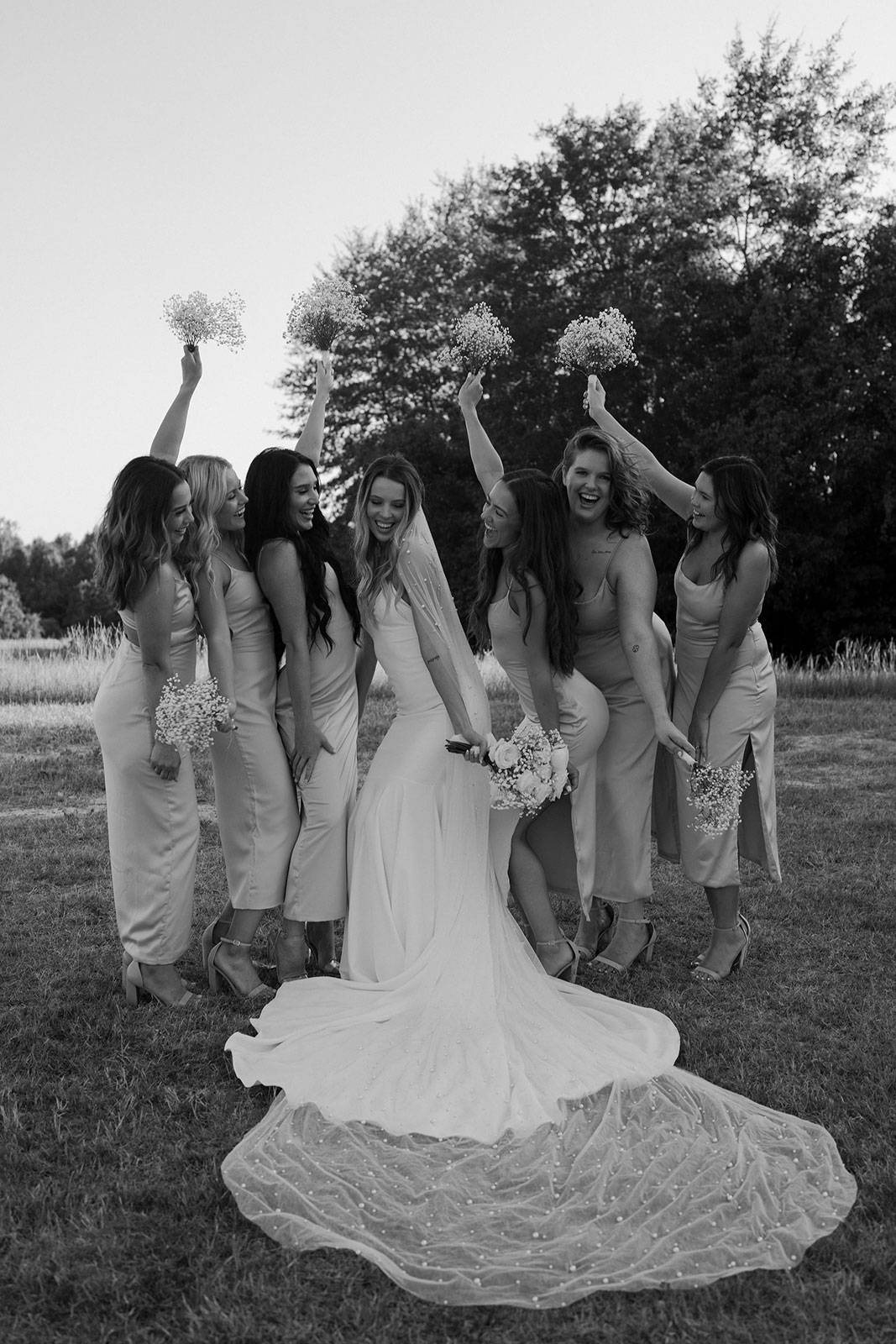 Bride laughing with bridesmaids