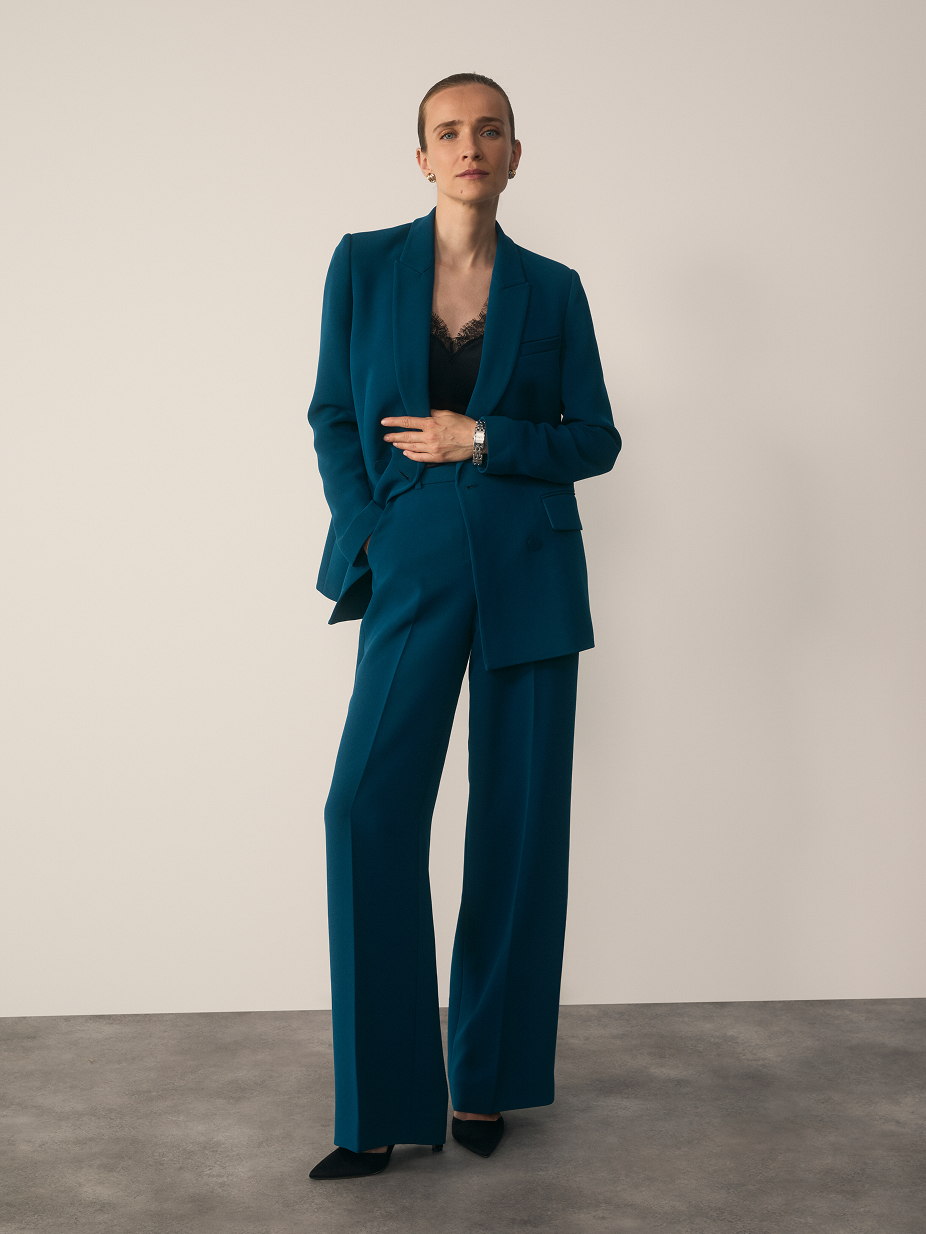 Model wearing Clever Crepe Doppio suiting in Dark Teal