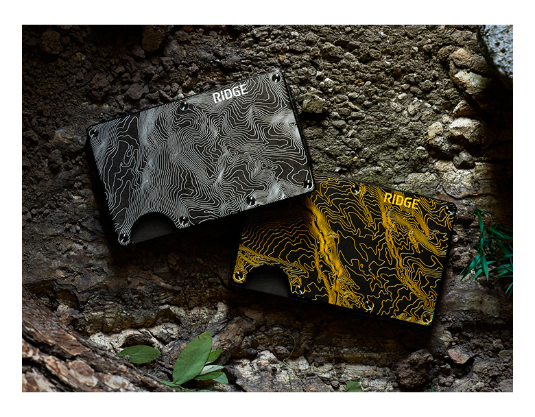 Two wallets, one black and one yellow, on a textured surface.