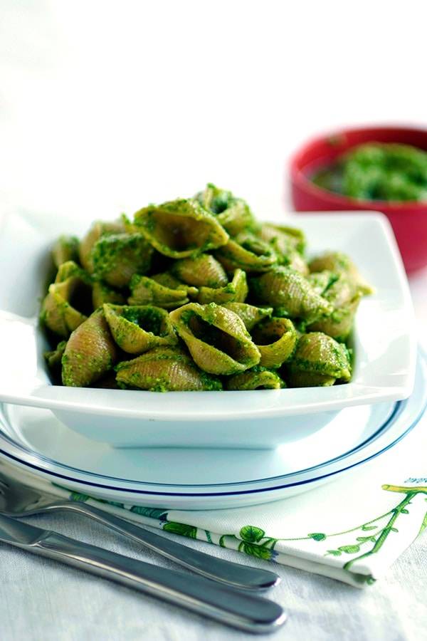 Pasta shells with a vibrant green arugula pesto