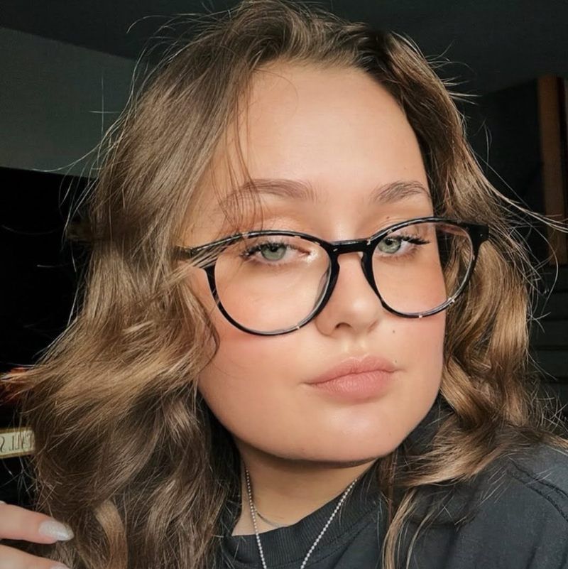 Woman wearing Hope Black, tortoiseshell eyeglasses