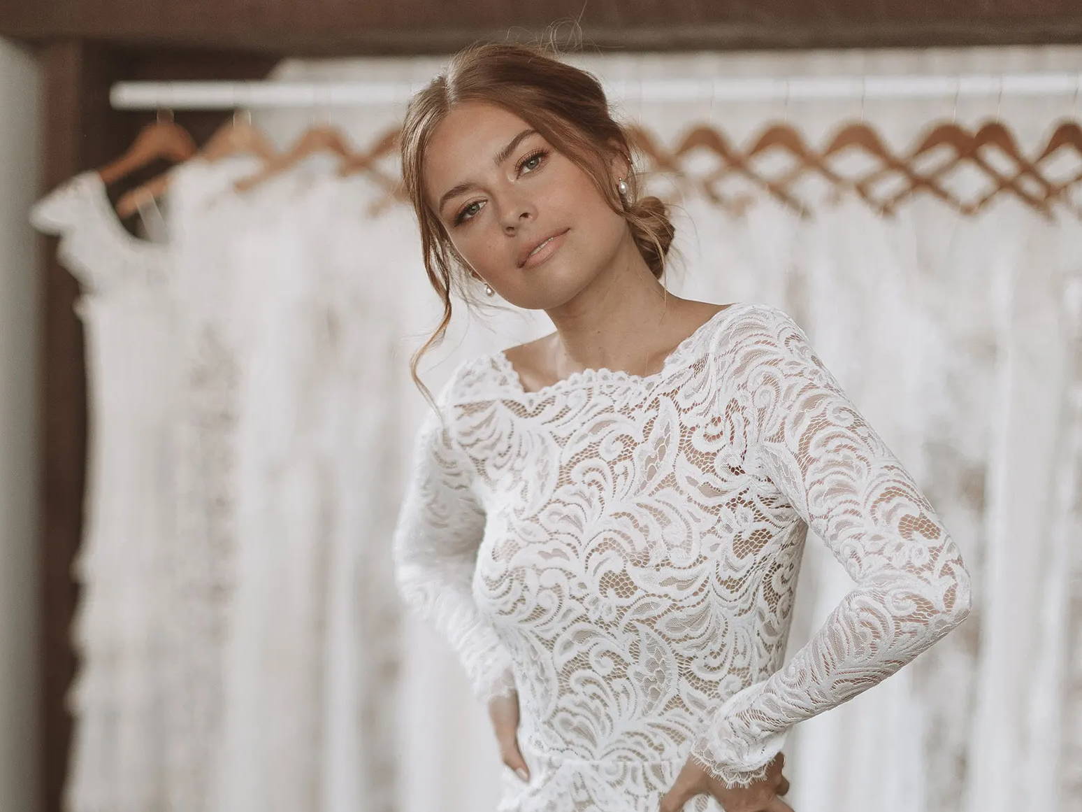 Bride wearing a long sleeve lace dress with chai lining