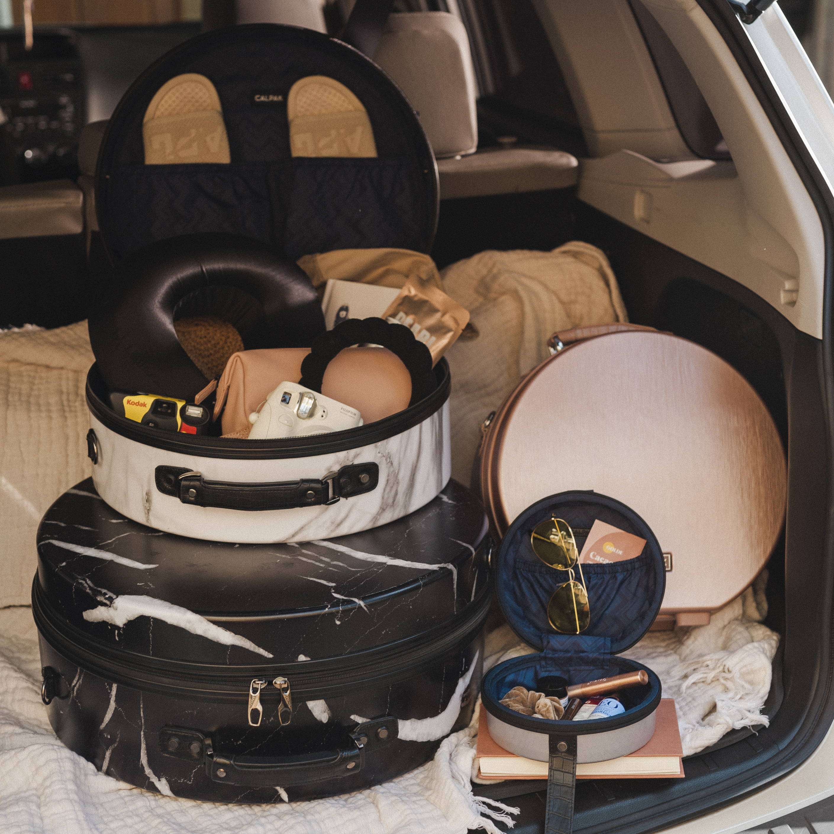 CALPAK Baye Hatboxes packed into the back end of a car.