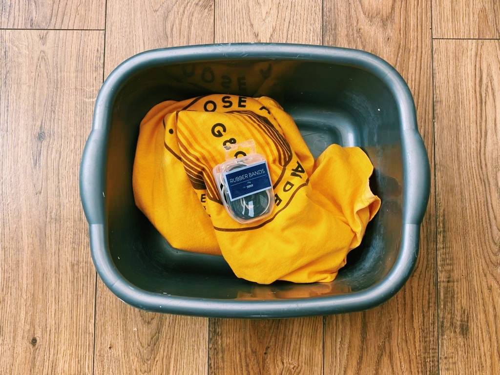 Rubber bands and t-shirt in washing bowl