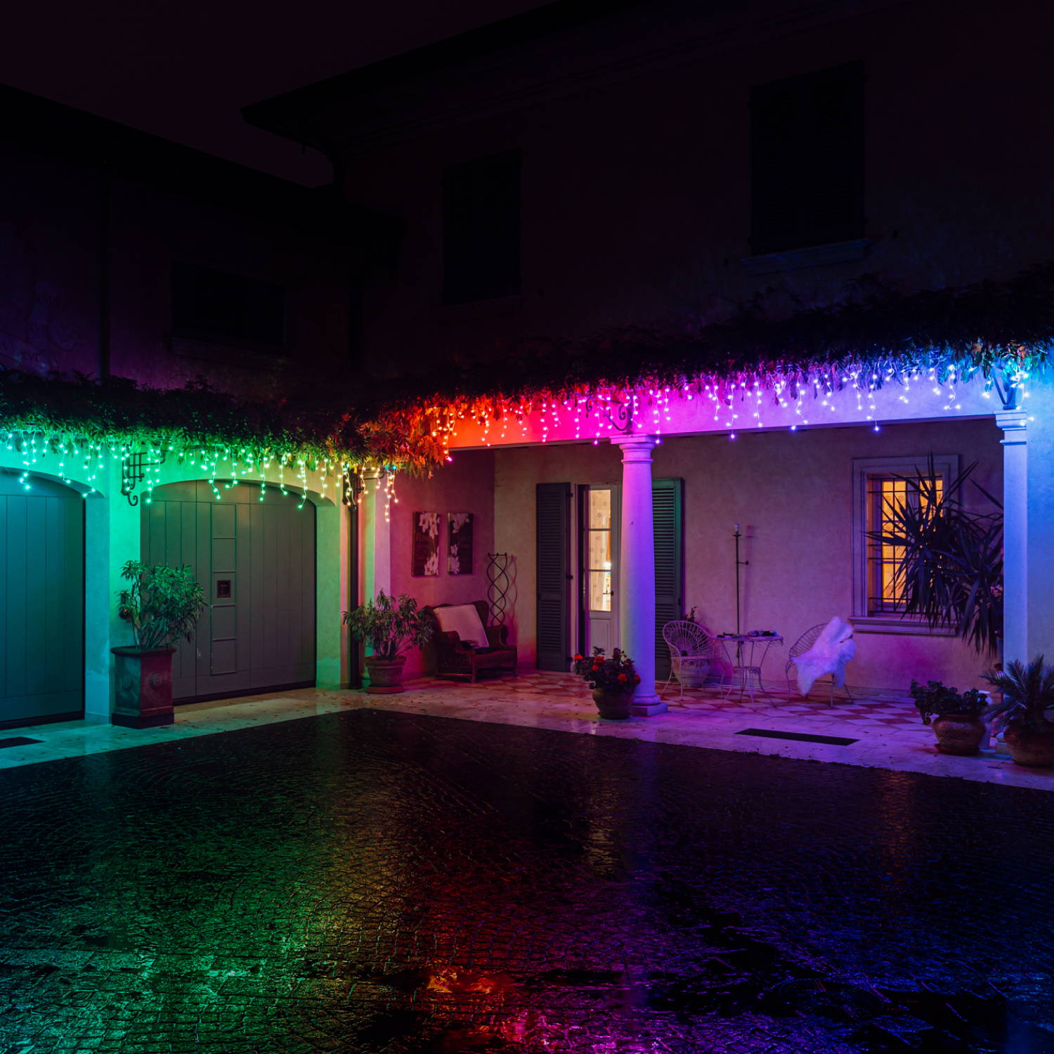 Multi coloured Twinkly icicle lights displayed along roof edge