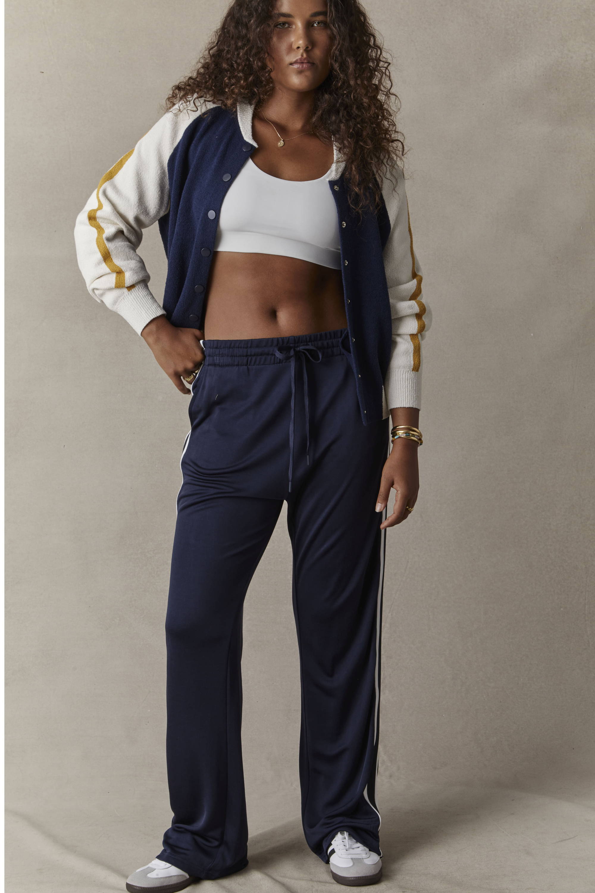 THE UPSIDE navy Celeste Pant worn with the navy Club Hallie Knit Bomber and white Peached Jade Bra.