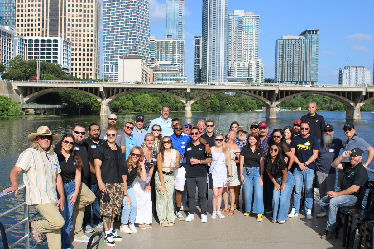 Group of solar professionals on boat with Austin city skyline in the background
