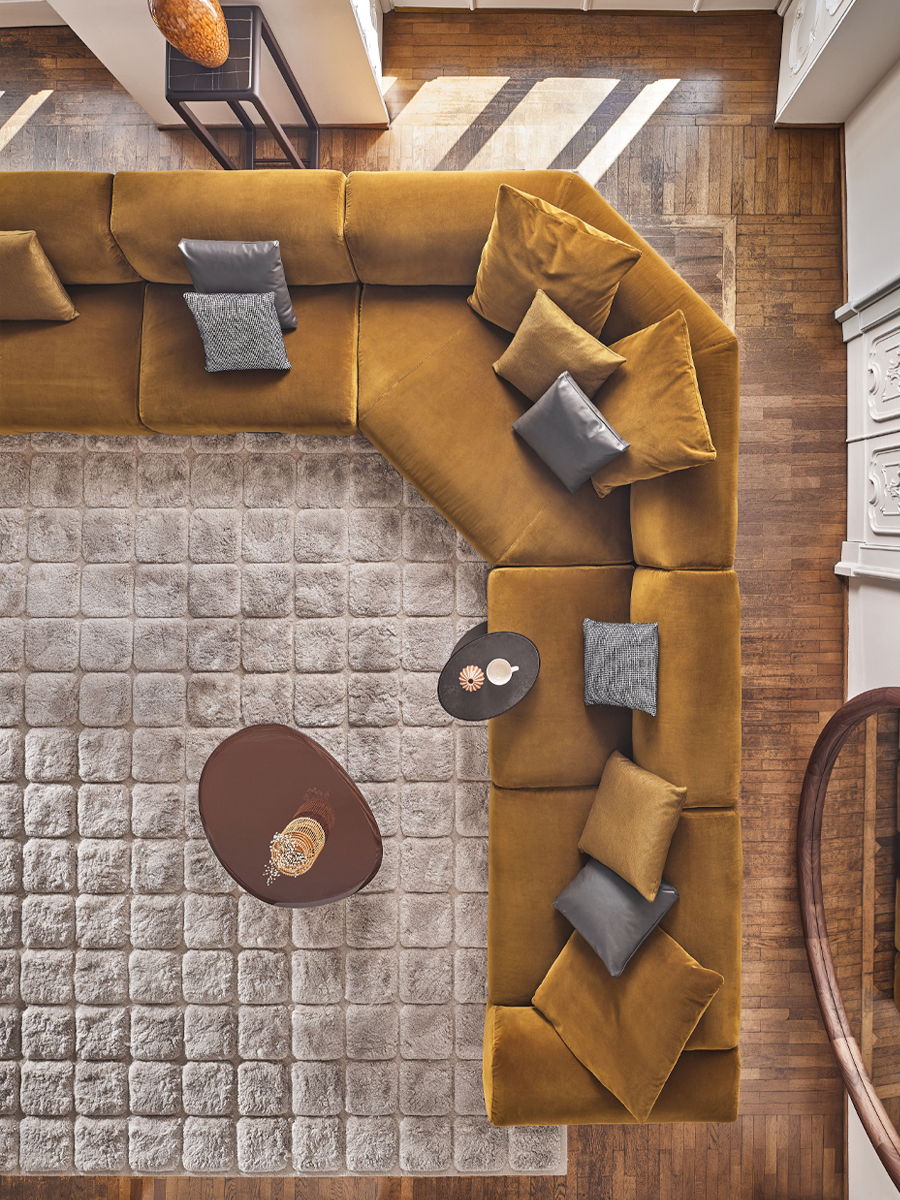 Aerial view of a cozy living room with a sectional sofa and coffee table.