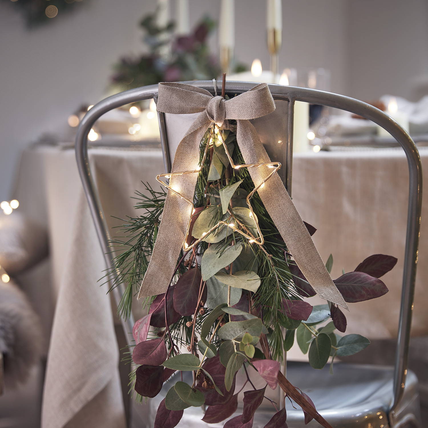 A cluster of natural sprigs affixed with a hessian bow, finished with a warm white LED star light 