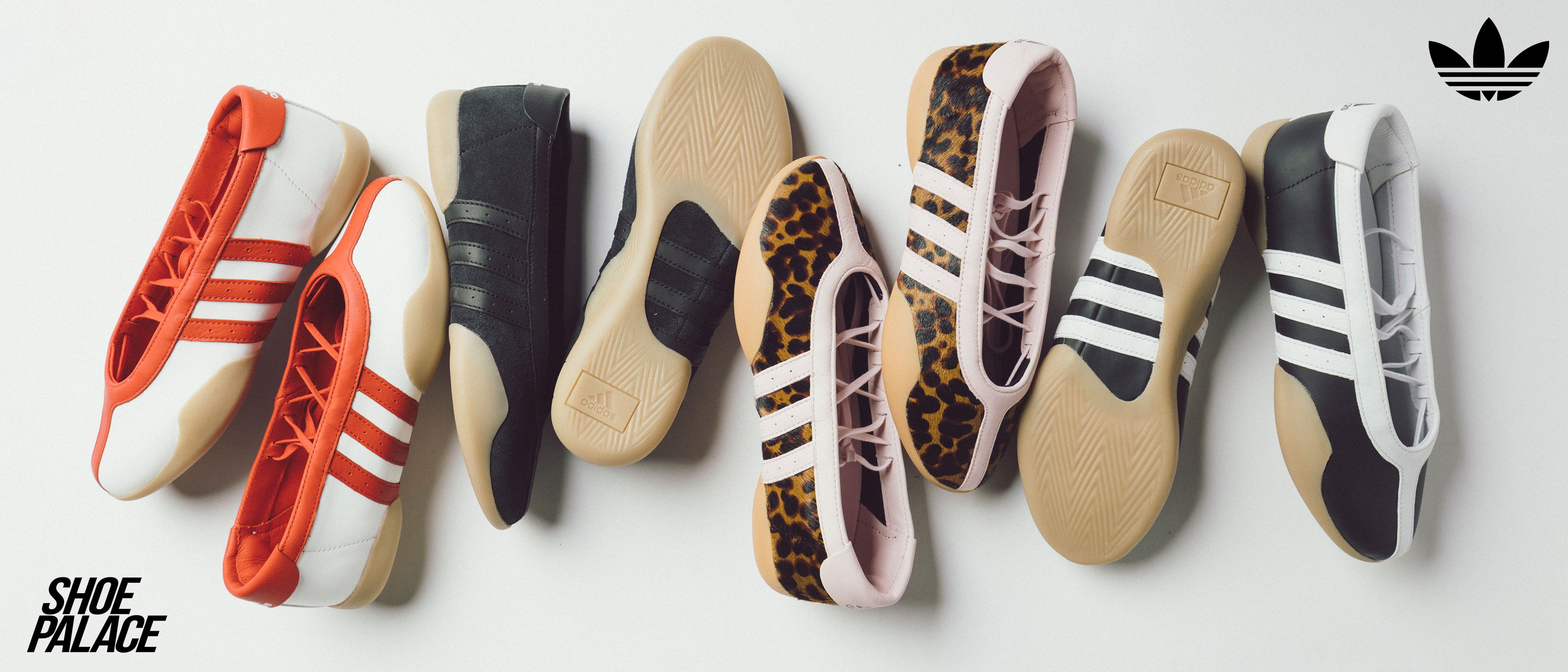 A collection of stylish sneakers arranged on a flat surface.
