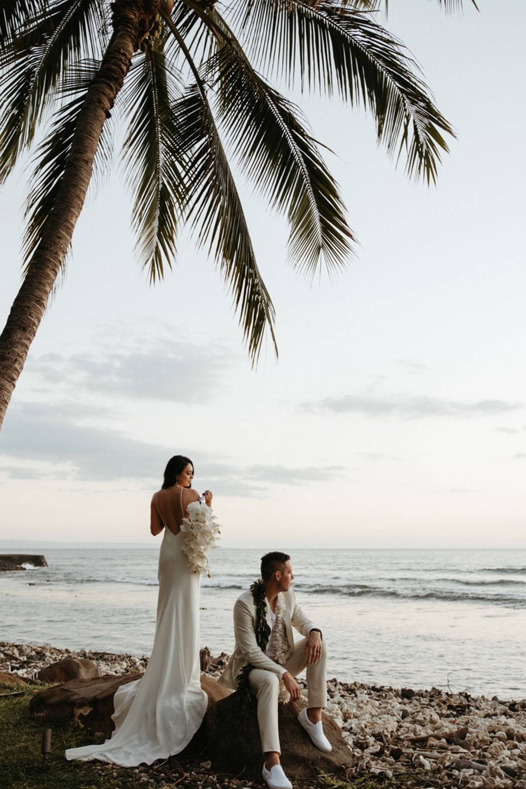 Bride and groom overlooking the ocean from shoreline