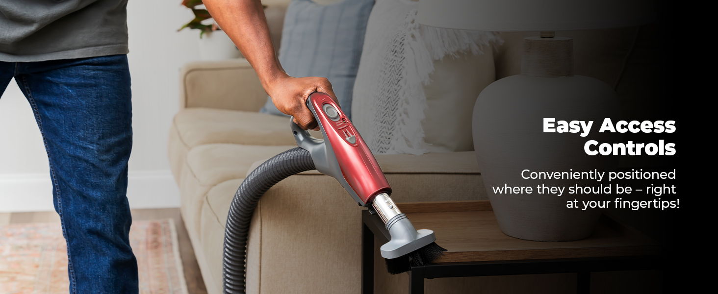 Person using a vacuum with easy access controls.