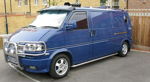 Front three-quarter deep blue Volkswagen Eurovan chrome bull bar spotlights roof Shocker XL train horns chrome side bar Will's featured gallery photo 1