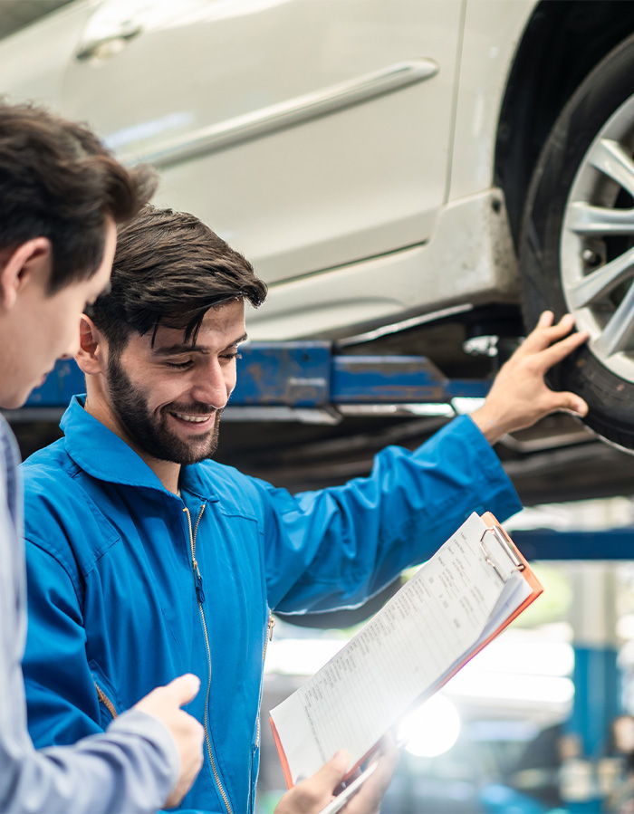 Mechanic and client in tyre shop
