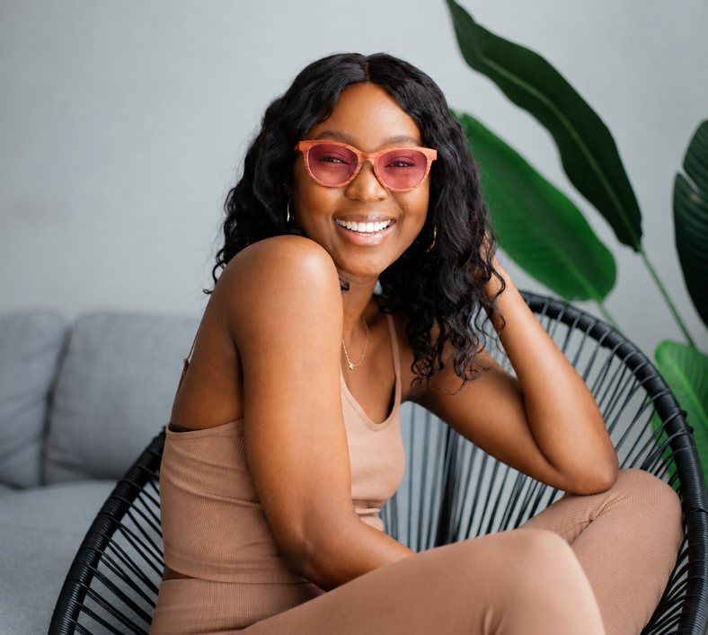 Woman smiling wearing rose tinted fl41 glasses