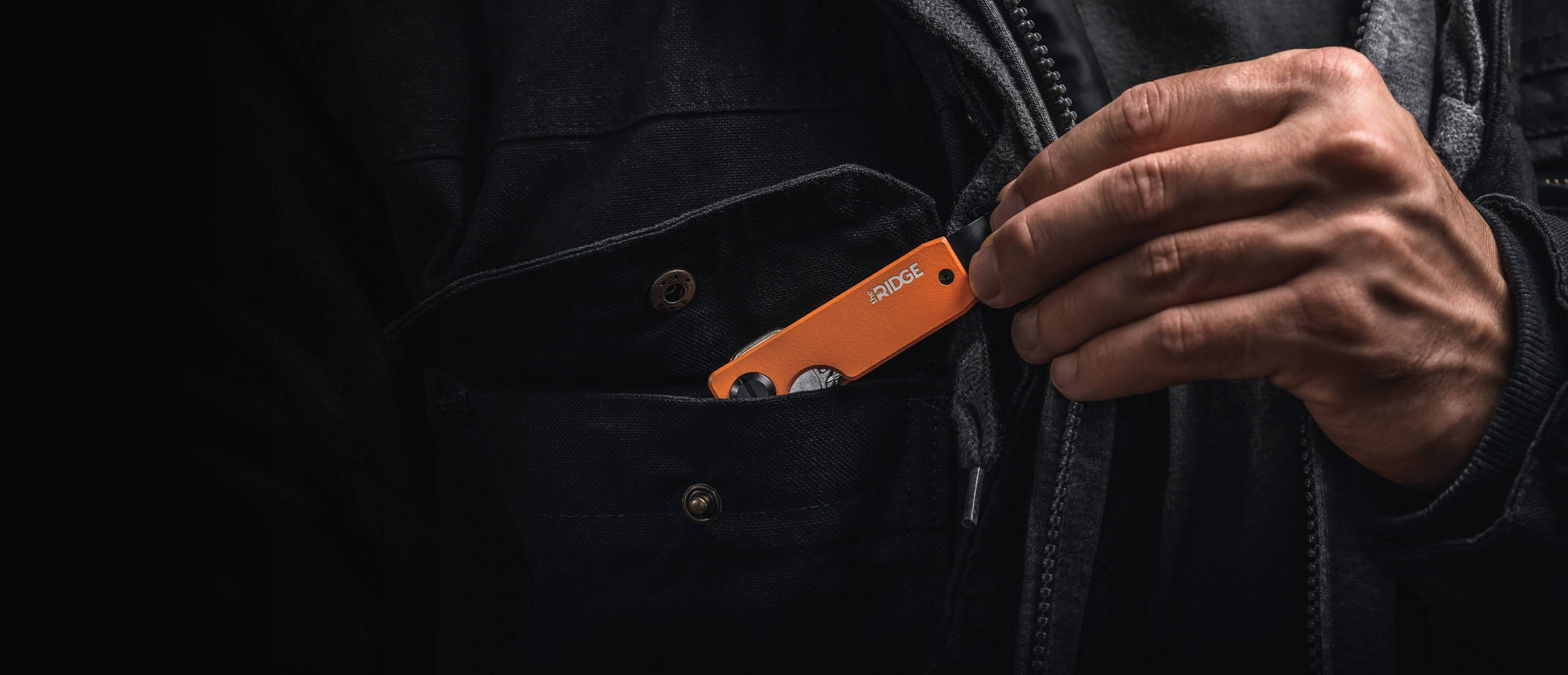 Basecamp Orange Ridge keycase pulled out from chest pocket