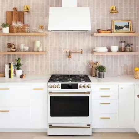 Modern kitchen with BOXI white cabinets, matte white range, and wooden shelves.