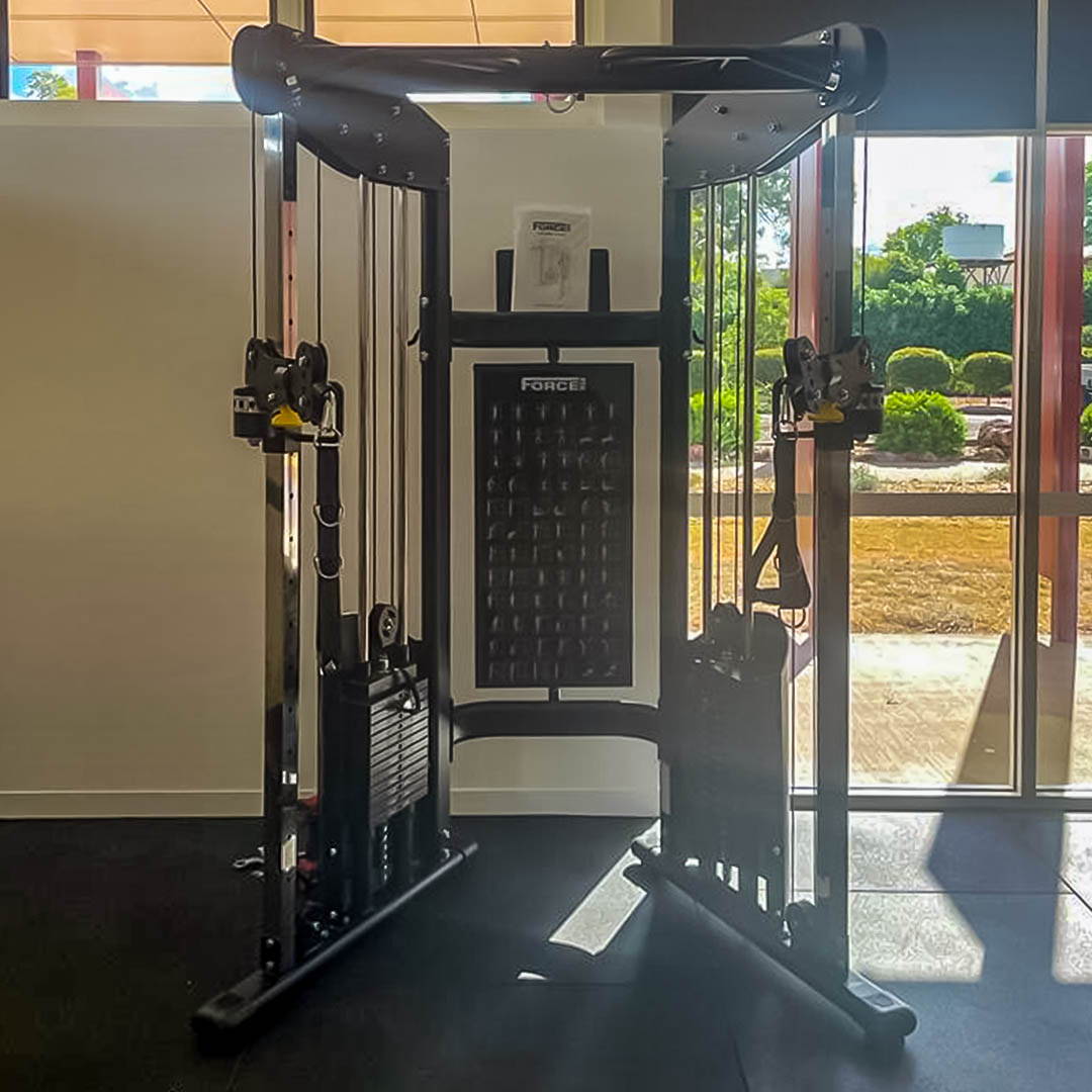 Force USA functional trainer, a centerpiece of the high school gym fit-out, equipped for versatile full-body conditioning.