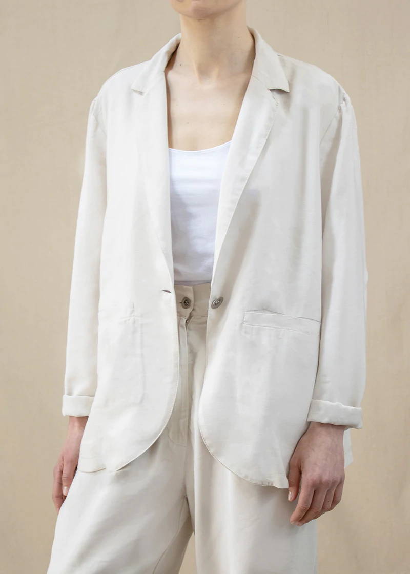 A model wearing a cream tailored jacket