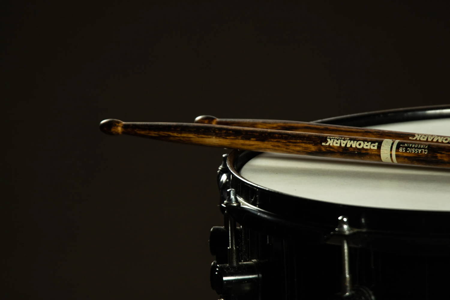 Drumsticks resting on a snare drum