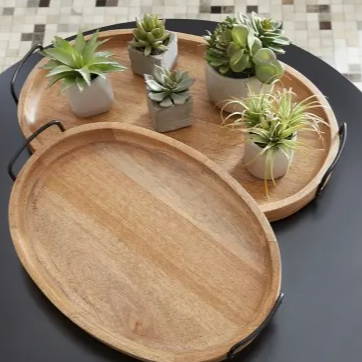 Two wooden trays with several succulent plants on it.