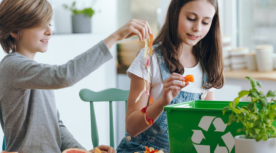 children adding waste to a composter