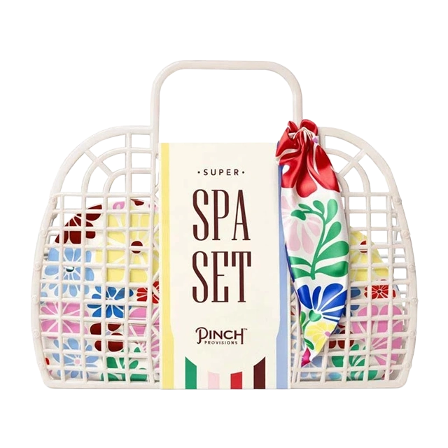 White basket with colorful spa set and floral scarf.