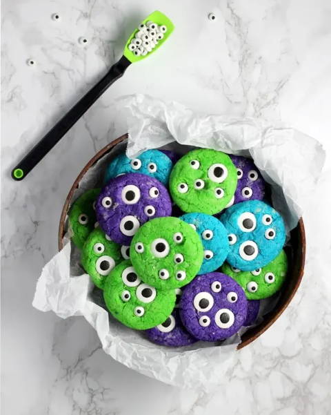 Image of green, blue and purple cookies with eyes in them.