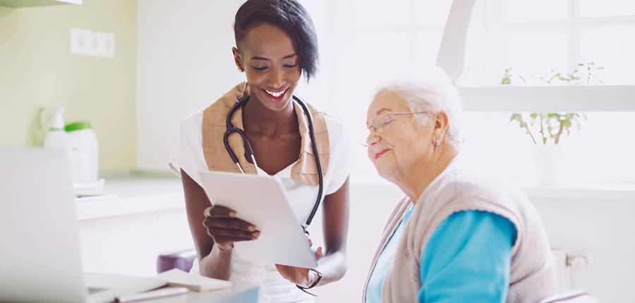 woman looking over test results with her doctor