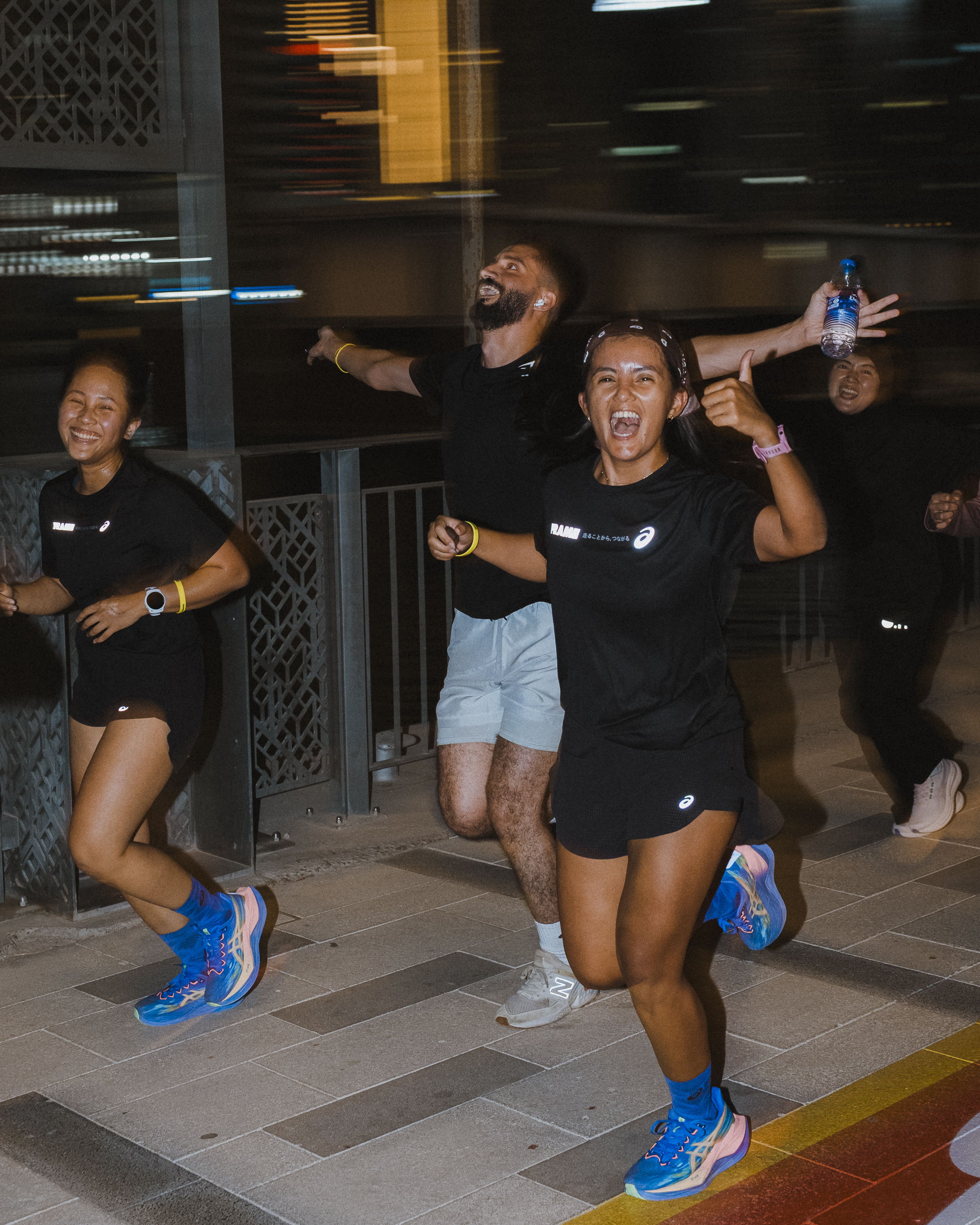 Runners enjoying a community run along the Dubai Canal during Global Running Day with ASICS and FRAME RUN CLUB in Dubai Design District.