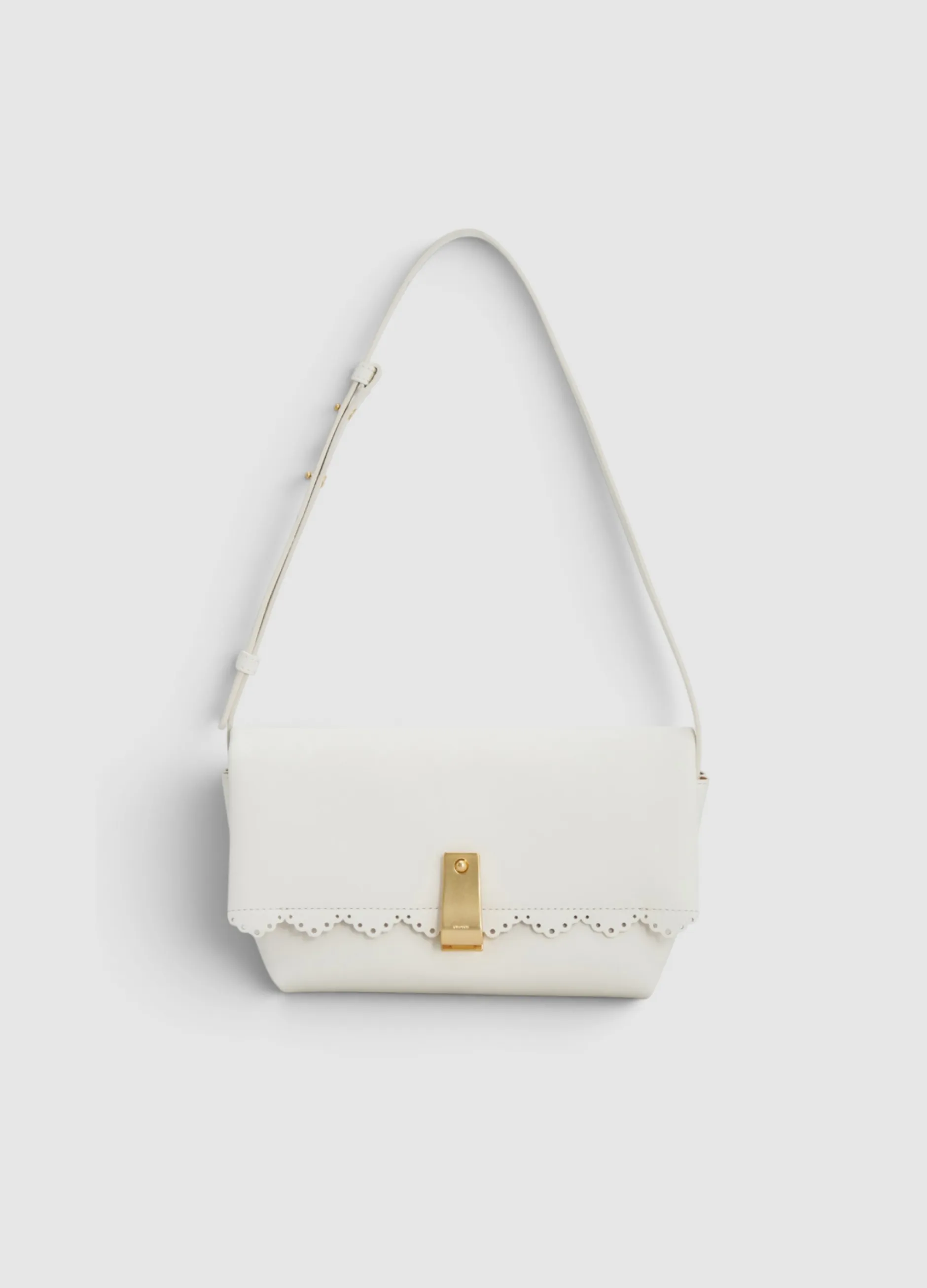 White handbag with a gold clasp and decorative edge.