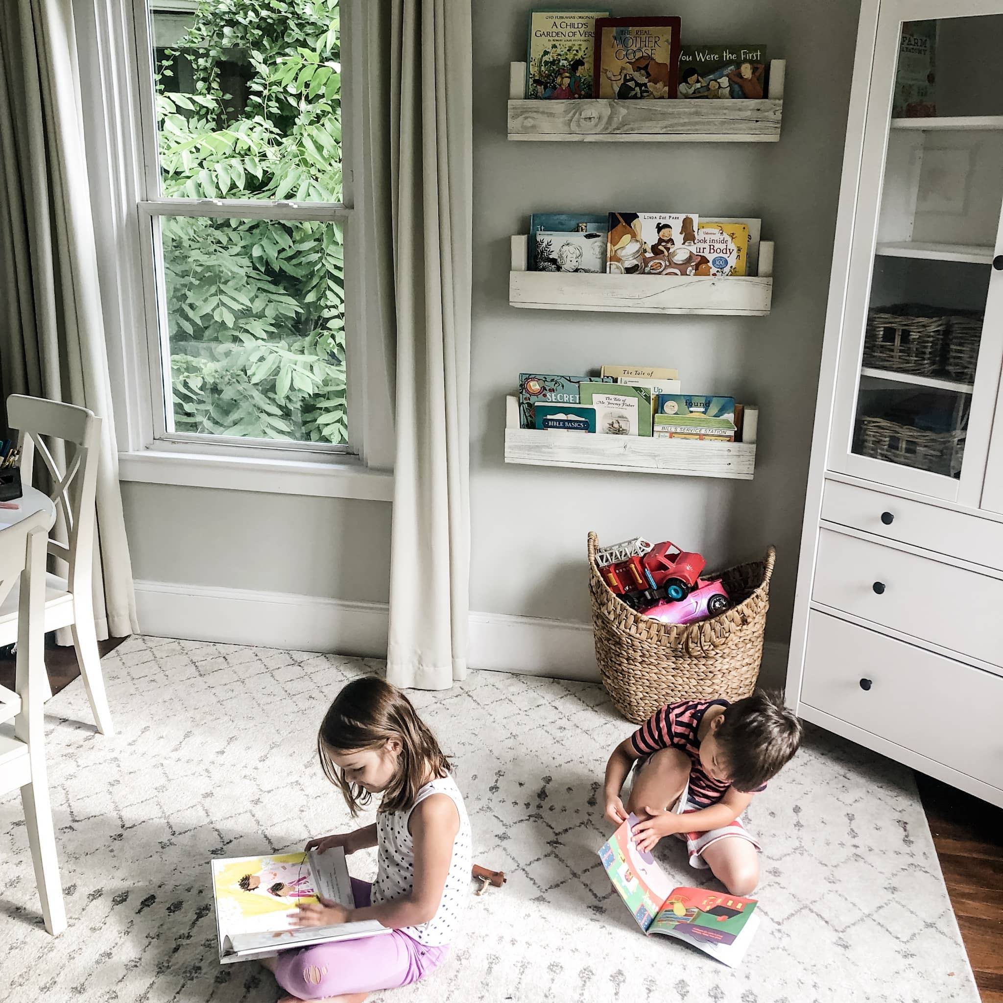 nursery room with books and kids reading