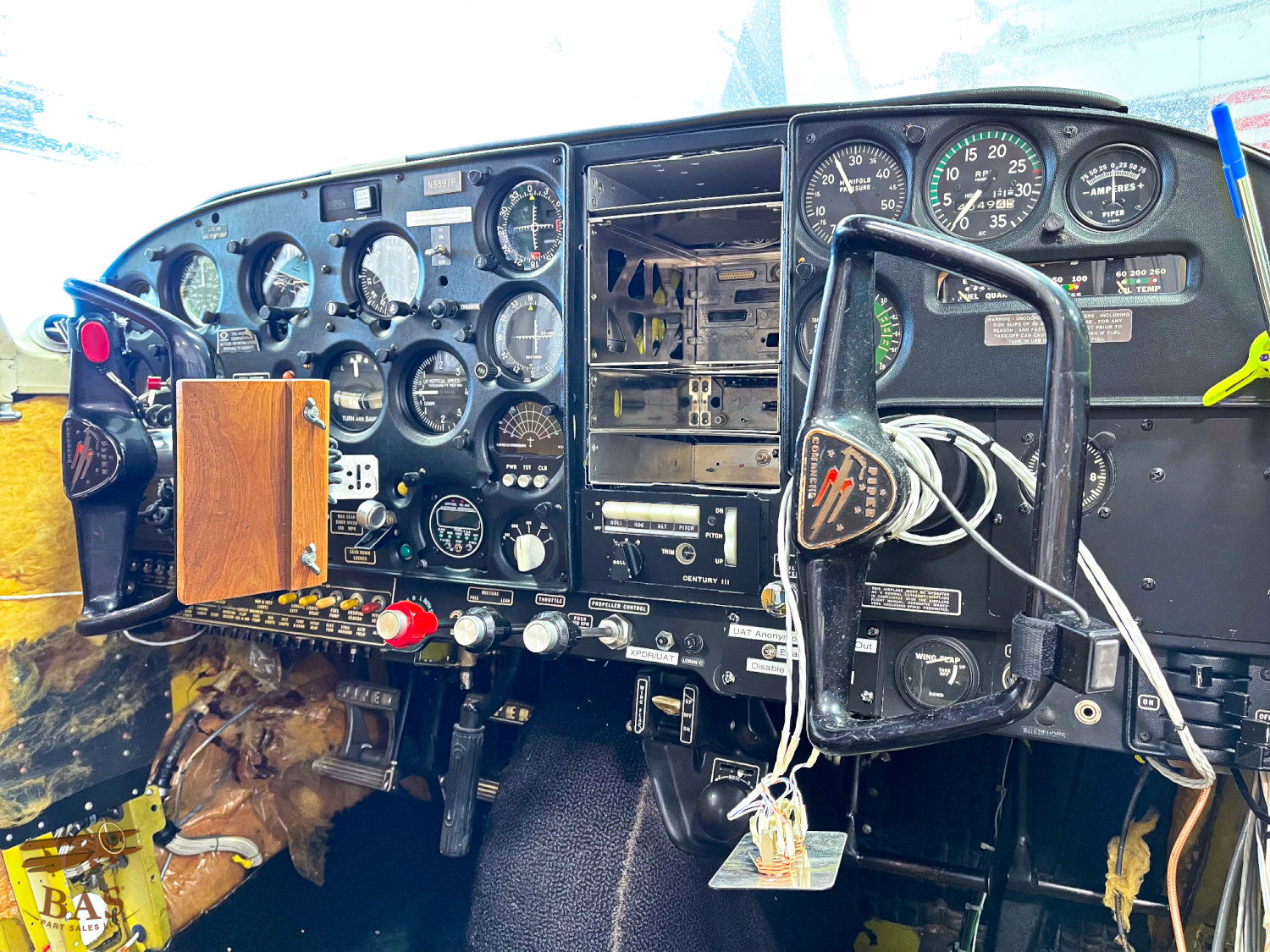 Cockpit view with instruments, controls, and gauges of an aircraft.