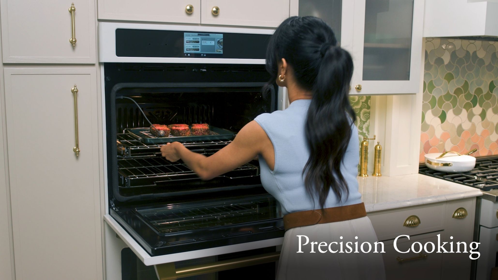 Person using an oven to cook food in a kitchen.