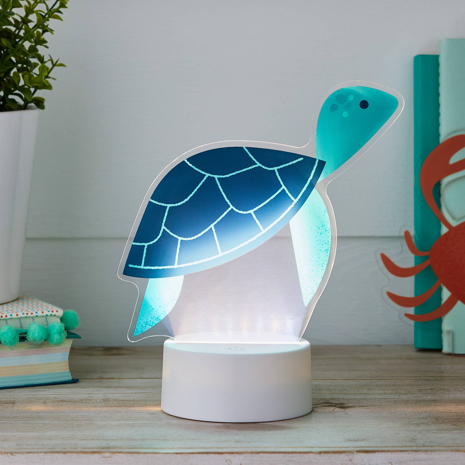 Turtle side table light on a wooden table in a bedroom.