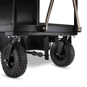 Close-up of a black cart with sturdy rubber wheels.
