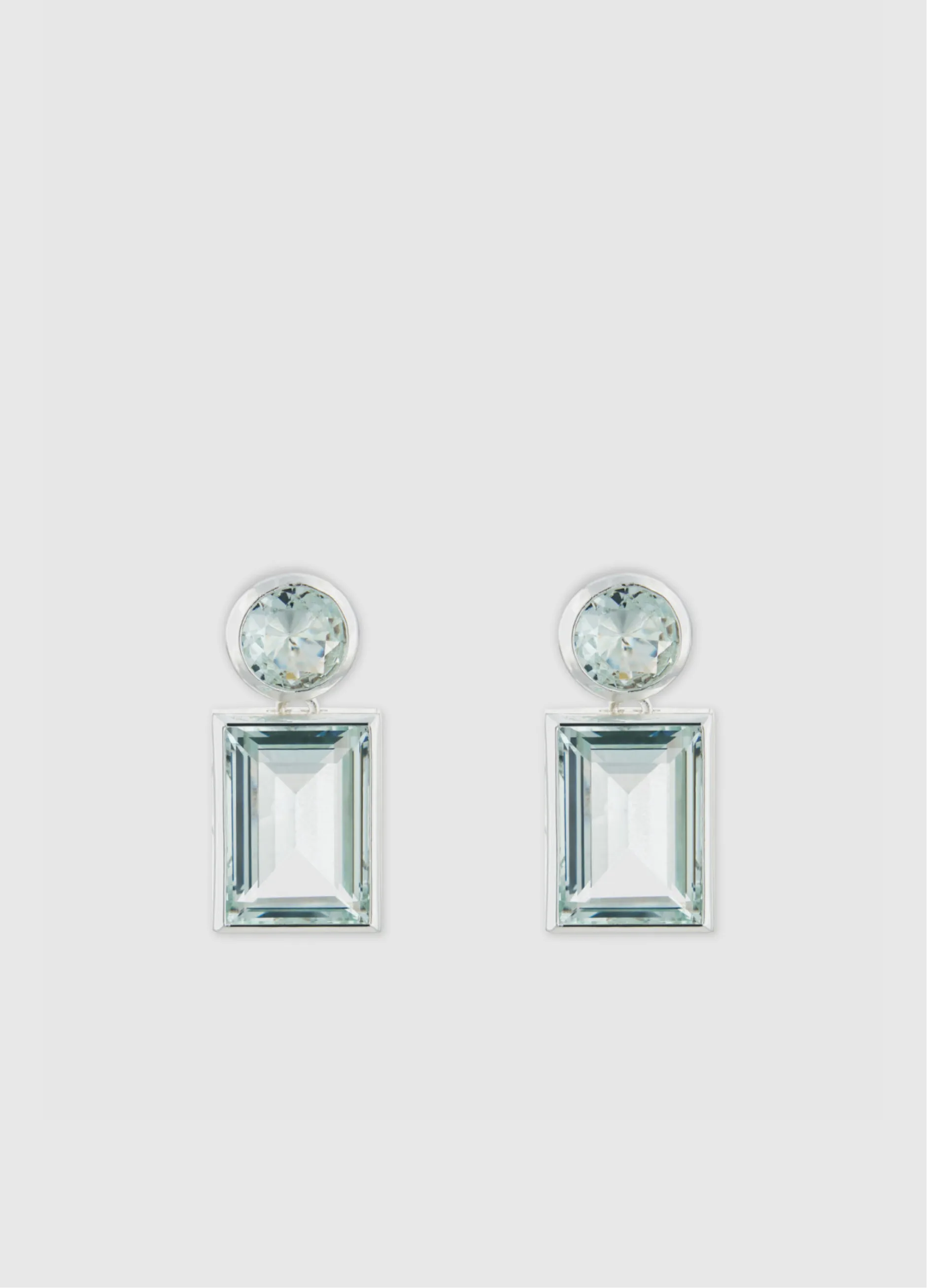 Pair of elegant earrings with rectangular and circular gemstones.