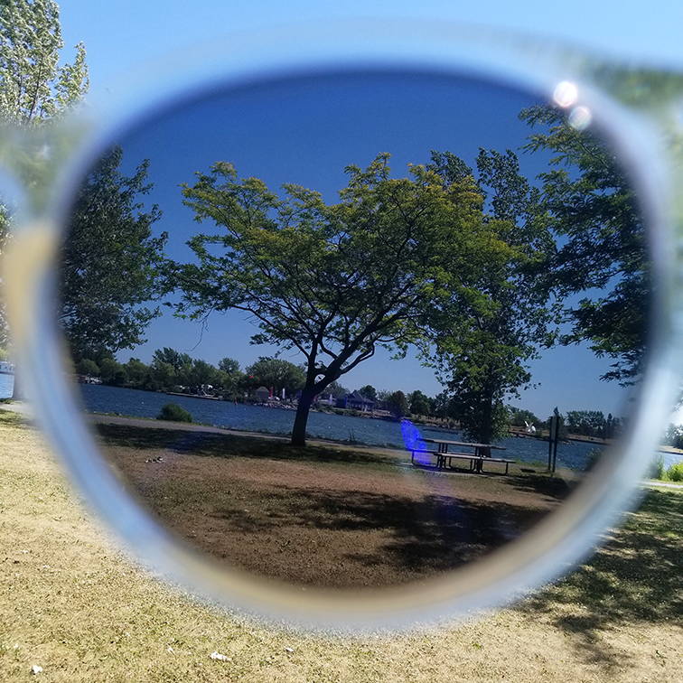Lake scenery through polarized lenses outdoors in the sun