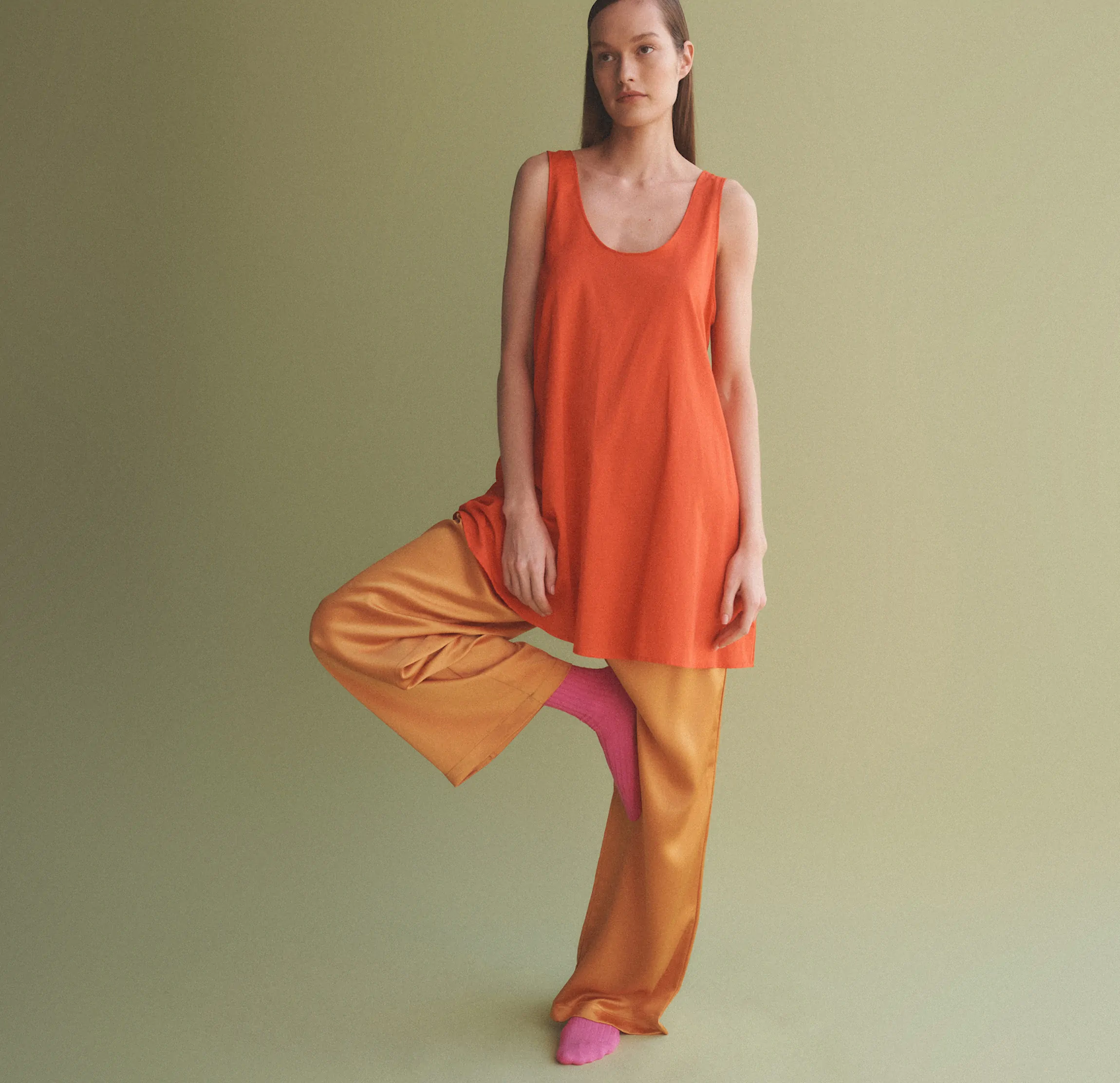 woman standing with one foot on thigh