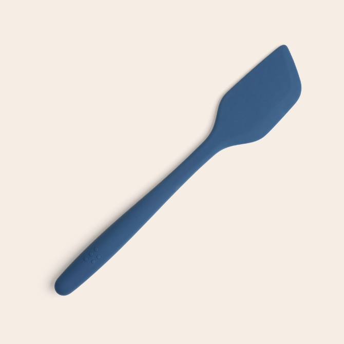 A blue Misen Silicone Spatula seen from above, with raised Misen logo visible on its ergonomic handle.