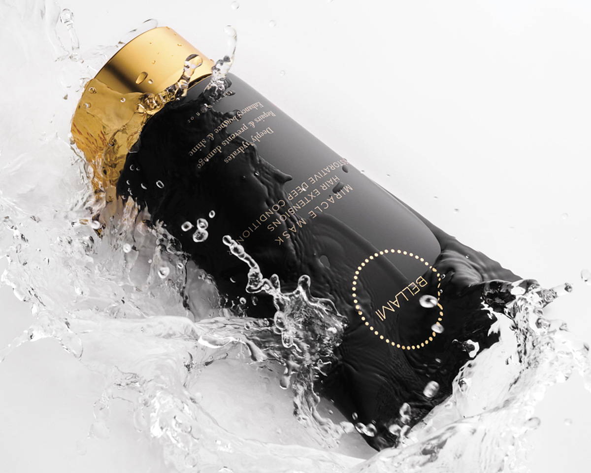Bellami hair care bottle with a black and gold design, splashed with water, creating a refreshing and hydrating visual effect.