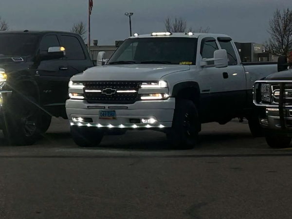 Front view of James' white 2001 Chevrolet Silverado 2500HD with lights on at dusk, Conductor's Special 127H train horn install photo 1