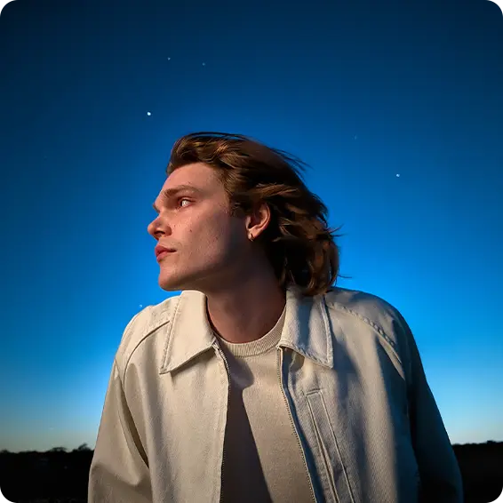 Person with long hair gazing at the starry night sky.