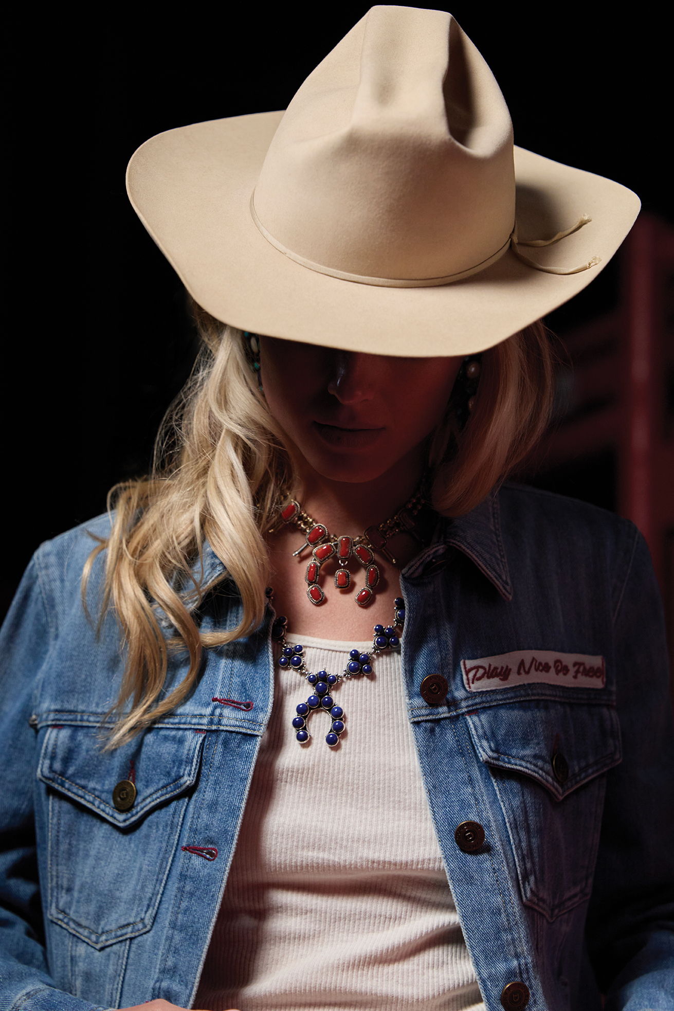 Haley wearing the Old Glory and Grit jacket with layered squash blossom necklaces and a vintage Double D Ranch hat.